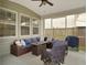 Cozy screened porch featuring wicker furniture and ceiling fan at 1011 Mossy Rock Dr, Summerville, SC 29485