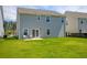 Spacious backyard with a two-story house and a patio area at 113 Corvus St, Summerville, SC 29483