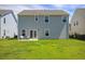 Spacious backyard with a two-story house and a patio area at 113 Corvus St, Summerville, SC 29483