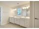 Double vanity bathroom with white cabinets and tiled floor at 113 Corvus St, Summerville, SC 29483