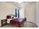 Cozy bedroom with a metal bed frame and dark-colored bedding, wood-look flooring and window coverings at 113 Corvus St, Summerville, SC 29483