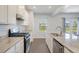 Modern kitchen with granite countertops, stainless steel appliances, and white cabinets at 113 Corvus St, Summerville, SC 29483