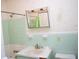 Small bathroom with light green tile and vanity at 153 Davis Ter, Saint George, SC 29477