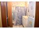 Bathroom with shower/tub combo, vanity, and nautical wallpaper at 153 Davis Ter, Saint George, SC 29477