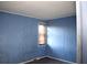 Small bedroom with blue wood paneling and a window with blinds at 153 Davis Ter, Saint George, SC 29477