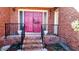Brick front porch with double pink door and black railing at 153 Davis Ter, Saint George, SC 29477
