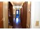 Long hallway with hardwood floors and access to bedrooms at 153 Davis Ter, Saint George, SC 29477