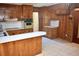 Retro kitchen with wood cabinets, built-in oven, and tile floor at 153 Davis Ter, Saint George, SC 29477