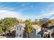 Aerial view of charming neighborhood with lush trees and a mix of architectural styles at 195 Saint Philip St, Charleston, SC 29403