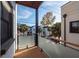 Private balcony with wood decking and glass railings offering city views at 195 Saint Philip St, Charleston, SC 29403