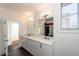 Modern bathroom with double vanity, quartz countertop and dark tile floor at 195 Saint Philip St, Charleston, SC 29403