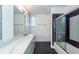 Modern bathroom with double vanity, quartz countertop, and dark tile floors at 195 Saint Philip St, Charleston, SC 29403