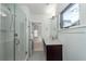 Bright bathroom with a glass shower, modern vanity, and tiled floor at 195 Saint Philip St, Charleston, SC 29403