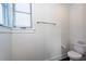 Simple bathroom with toilet, window, and dark tile floor at 195 Saint Philip St, Charleston, SC 29403