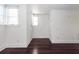 Empty bedroom with hardwood floors and two windows at 195 Saint Philip St, Charleston, SC 29403
