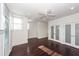 Spacious bedroom with hardwood floors, ceiling fan, and frosted glass closet doors at 195 Saint Philip St, Charleston, SC 29403