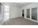 Bright bedroom with ceiling fan, carpet flooring, and ensuite bathroom access at 195 Saint Philip St, Charleston, SC 29403