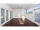 Bright bedroom with hardwood floors, double doors, and a ceiling fan at 195 Saint Philip St, Charleston, SC 29403