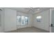 Spacious bedroom with large windows, ceiling fan, and neutral carpeting at 195 Saint Philip St, Charleston, SC 29403