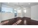 Bright bedroom with dark hardwood floors, recessed lighting, and private balcony access at 195 Saint Philip St, Charleston, SC 29403