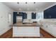 Modern kitchen with white and blue cabinets, quartz countertops and island at 195 Saint Philip St, Charleston, SC 29403