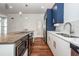 Modern kitchen with white cabinets, blue upper cabinets, and quartz countertops at 195 Saint Philip St, Charleston, SC 29403