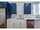 Modern kitchen with stainless steel appliances and white cabinets at 195 Saint Philip St, Charleston, SC 29403