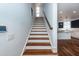 Modern staircase with wood treads and white risers, offering access to upper levels at 195 Saint Philip St, Charleston, SC 29403