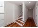 Modern staircase with hardwood treads and white risers at 195 Saint Philip St, Charleston, SC 29403