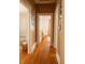 Long hallway with hardwood floors and charming photo displays at 203 Weiters St, Walterboro, SC 29488