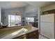 Kitchen with breakfast bar, white appliances, and view into living room at 32 Marsh Island (4 Shares) Ln, Isle of Palms, SC 29451