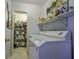Bright laundry room with washer, dryer, and ample storage shelving at 32 Marsh Island (4 Shares) Ln, Isle of Palms, SC 29451