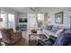 Spacious living room with hardwood floors, fireplace, and deck access at 32 Marsh Island (4 Shares) Ln, Isle of Palms, SC 29451