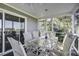 Screened porch with glass table and chairs, ceiling fan at 32 Marsh Island (4 Shares) Ln, Isle of Palms, SC 29451