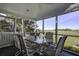 Spacious screened porch with glass top table and marsh view at 32 Marsh Island (4 Shares) Ln, Isle of Palms, SC 29451