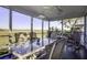 Relaxing screened porch with rocking chair and marsh views at 32 Marsh Island (4 Shares) Ln, Isle of Palms, SC 29451
