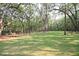 Spacious dog park with benches, trees, and grassy area at 4135 Collins Dr, Charleston, SC 29414