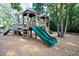 Wooden playground structure with slides, climbing features, and wood chips at 4135 Collins Dr, Charleston, SC 29414