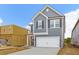 Two-story gray house with white garage door and brown front door at 422 Grove End Rd, Moncks Corner, SC 29461