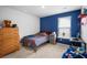 Blue-walled bedroom with a bed and dresser at 671 Silver Spruce St, Summerville, SC 29486