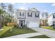 Two-story house with gray siding, a white garage door, and a well-maintained lawn at 671 Silver Spruce St, Summerville, SC 29486