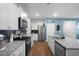 Modern kitchen with white cabinets, granite countertops, and stainless steel appliances at 671 Silver Spruce St, Summerville, SC 29486