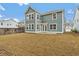 Large backyard with a two-story house, wooden fence, and grassy lawn at 758 Maynard Ln, Summerville, SC 29486