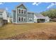 View of a large backyard, a two-story house and neighboring houses at 758 Maynard Ln, Summerville, SC 29486