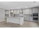 Modern kitchen with gray cabinets, quartz countertops and stainless steel appliances at 758 Maynard Ln, Summerville, SC 29486