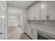 Modern kitchen with white cabinets and gray herringbone backsplash at 758 Maynard Ln, Summerville, SC 29486