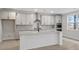 Modern kitchen with gray cabinets, quartz countertops, and a large island at 758 Maynard Ln, Summerville, SC 29486