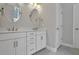 Double vanity bathroom with white cabinets and gray tile floor at 780 Maynard Ln, Summerville, SC 29486