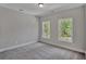 Spacious bedroom with grey walls and carpet, featuring two large windows at 780 Maynard Ln, Summerville, SC 29486