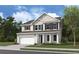Two-story home with beige siding, dark brown accents, and a two-car garage at 780 Maynard Ln, Summerville, SC 29486